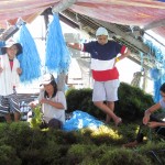 Workers split the latest harvest and attach half of it to new strands, effectively doubling the farmer’s crop.