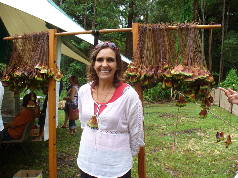 Beverly Hand, organizer of the Bunya Dreaming gathering, stands in front of welcome necklaces made of bunya seeds