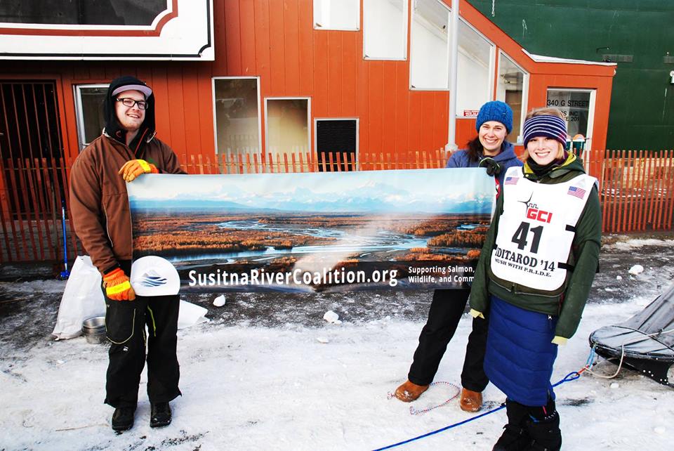 Lisbet Norris shows her support for the Susitna River Coalition at her first Iditarod run in 2014. (Photo credit C. Gibson.)