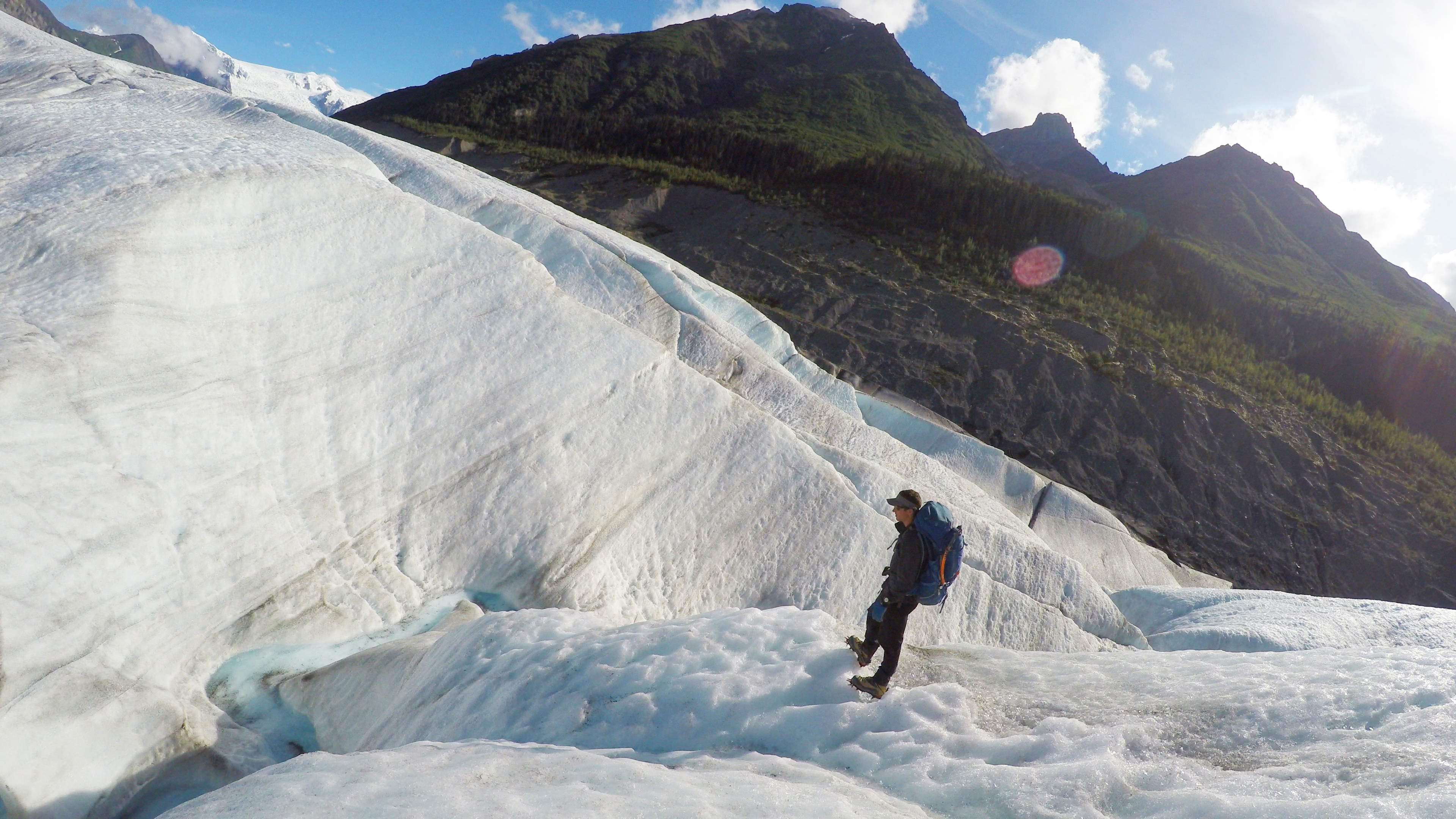 Cody and I stand on the Root glacier, aided by the crampons strapped on our feet which allow us to perch on icy cliffs and climb steep hills.